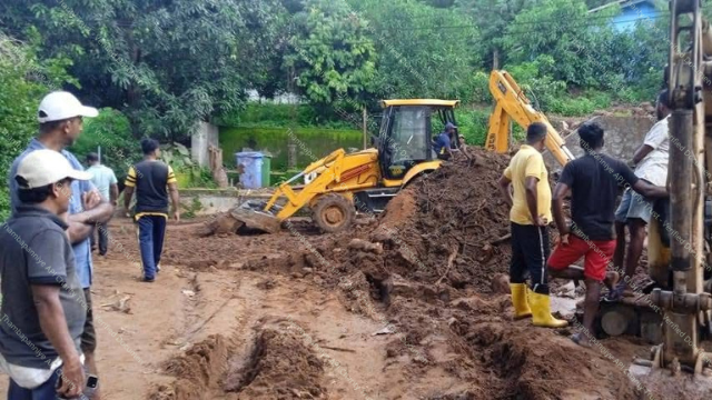 Wide view of landslide damage in the village