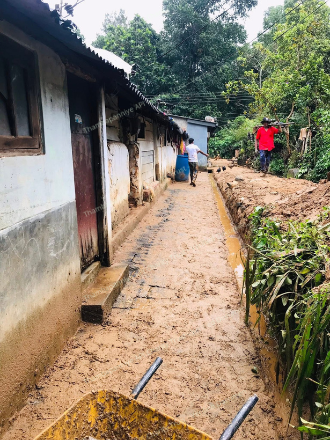 Homes along a slope with mud damage on the walkway
