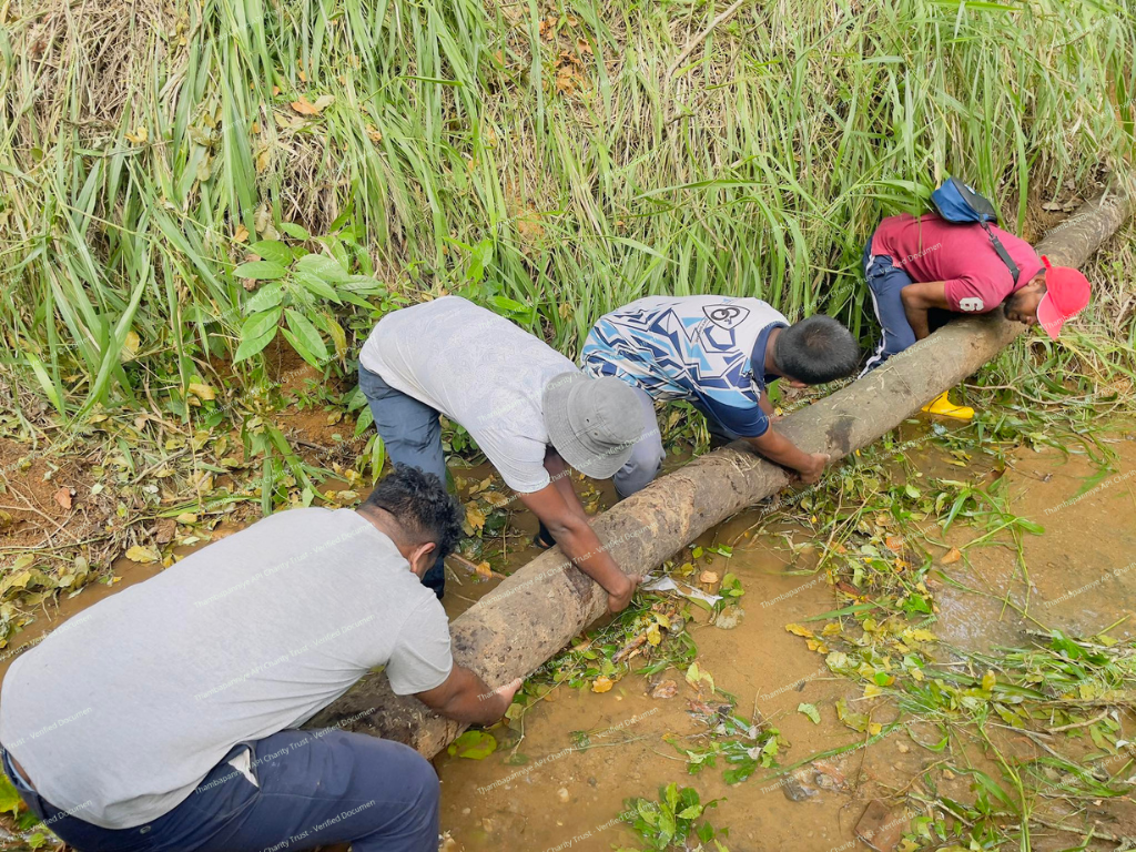 Residents removing mud around pipes and drainage lines