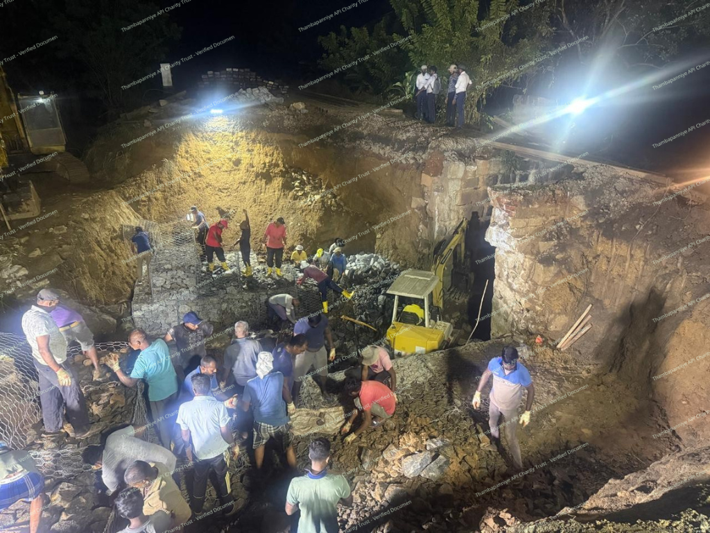 Nighttime rescue and excavation work under floodlights