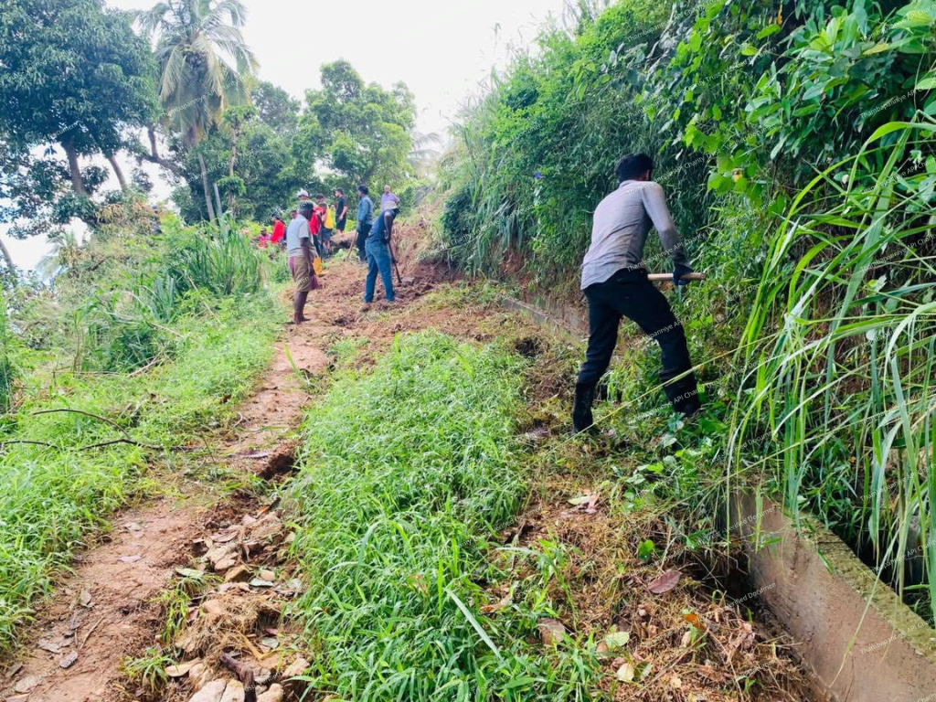 Village path covered with landslide debris and vegetation